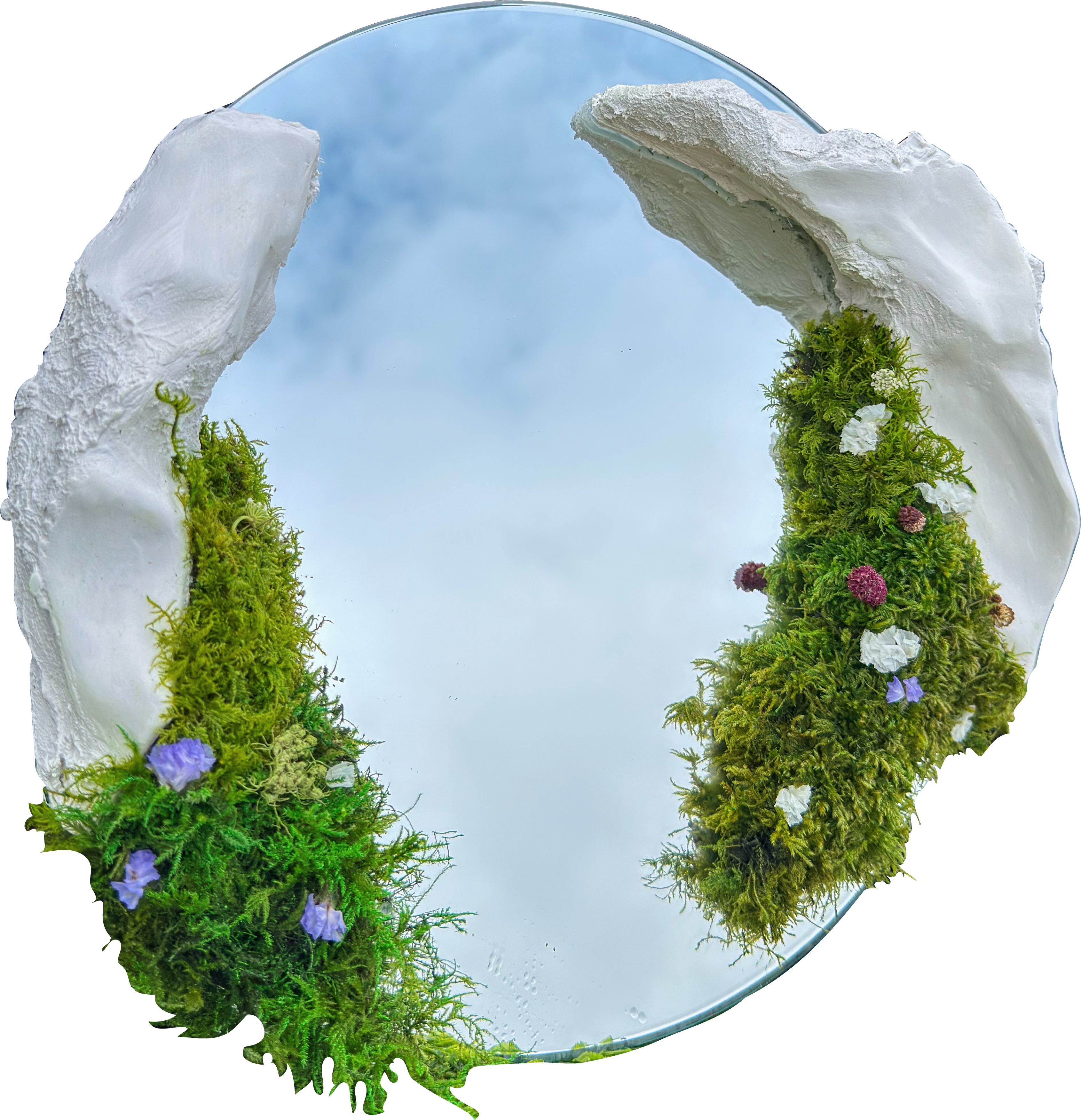 Round mirror framed by white sculpted fragments and moss